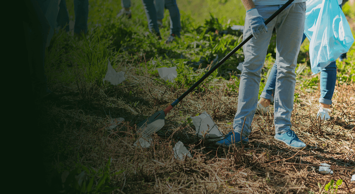 Spring cleanup with workers raking debris